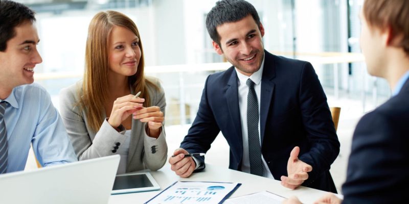 starting-a-business-in-India-for-foreign-company-1140×640 Three professionals in discussion at AlZarooni & Associates in Dubai.